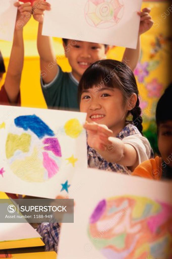 Stock Photo: 1188-949 Girl showing her drawing and smiling