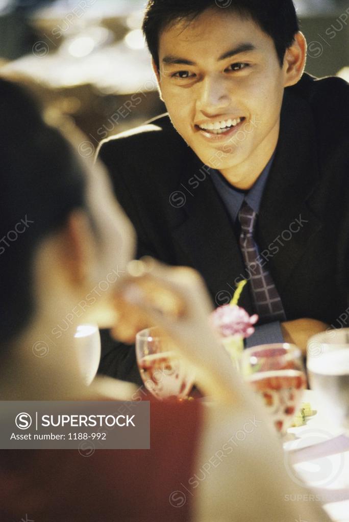 Stock Photo: 1188-992 Young couple looking at each other in a restaurant