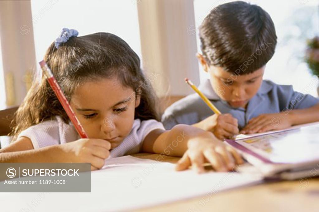 Stock Photo: 1189-1008 Girl and boy doing their homework