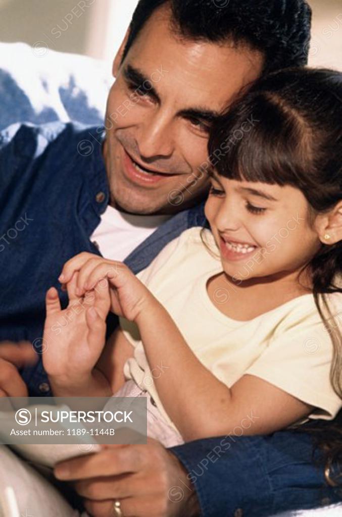 Stock Photo: 1189-1144B Mid adult man with his arm around his daughter