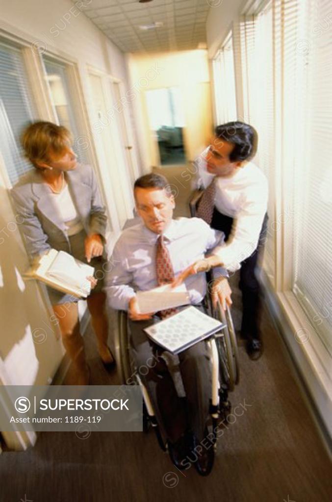 Stock Photo: 1189-119 High angle view of two businessmen with a businesswoman in a corridor