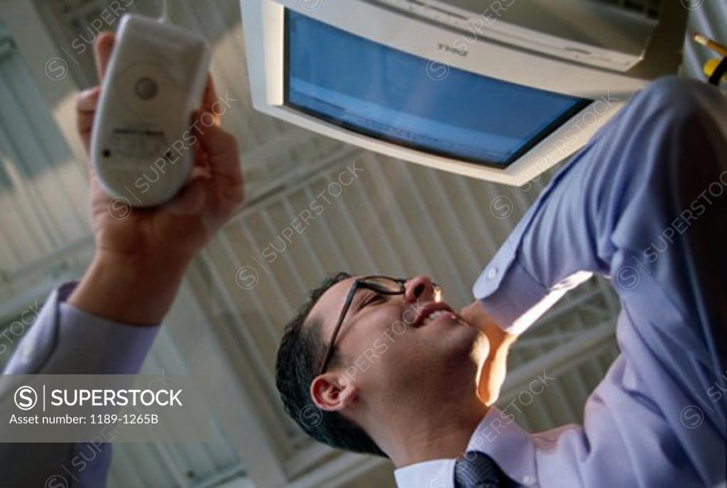 Stock Photo: 1189-1265B Low angle view of a businessman using a computer