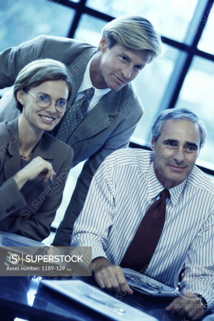 Stock Photo: 1189-129 Two businessmen and a businesswoman in a meeting