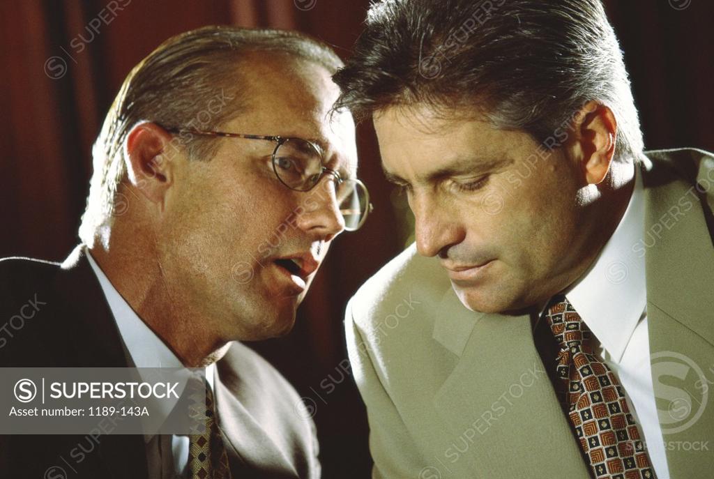 Stock Photo: 1189-143A Two businessmen talking in an office