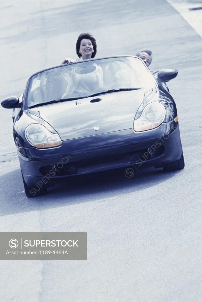 Stock Photo: 1189-1464A Portrait of a mid adult couple in a convertible car