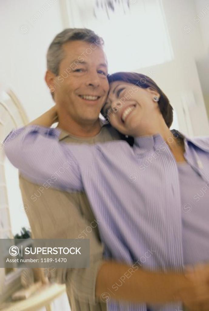 Stock Photo: 1189-1470 Portrait of a mid adult couple hugging