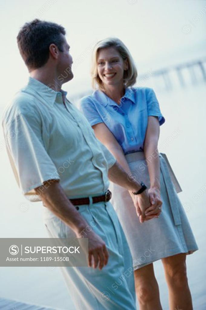 Stock Photo: 1189-1550B Mid adult couple walking and holding hands