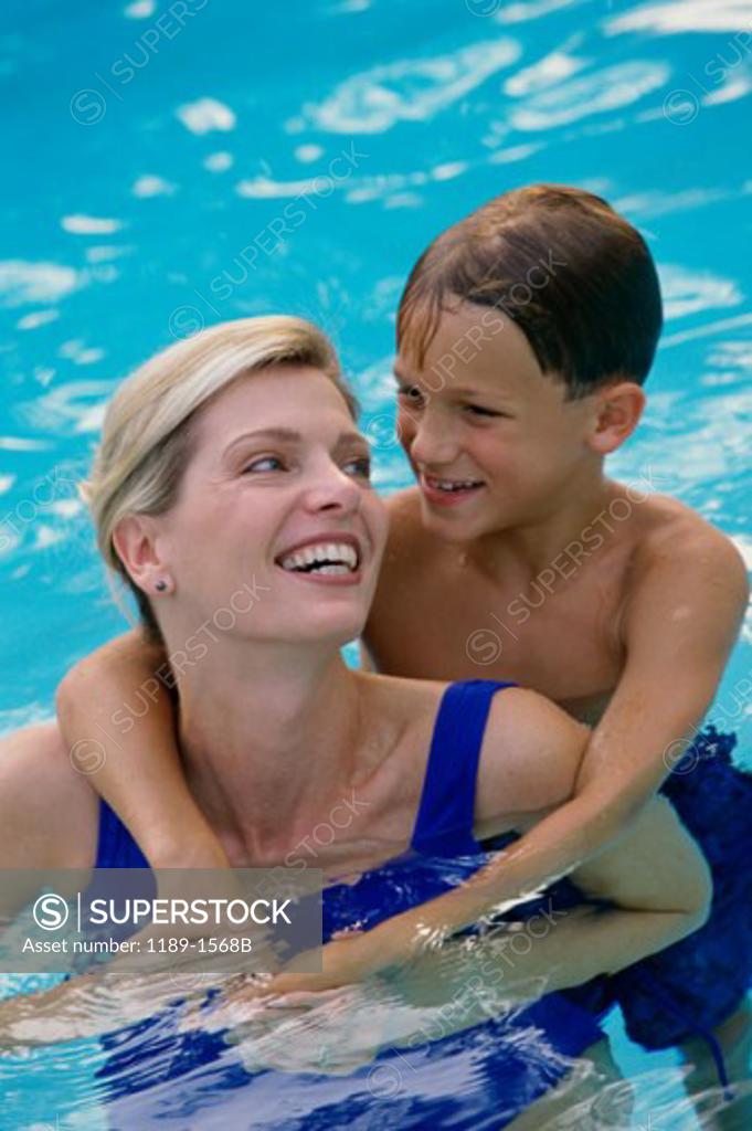 Stock Photo: 1189-1568B Mid adult woman with her son in a swimming pool
