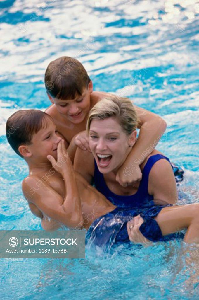 Stock Photo: 1189-1576B High angle view of a mid adult woman with her two sons in a swimming pool