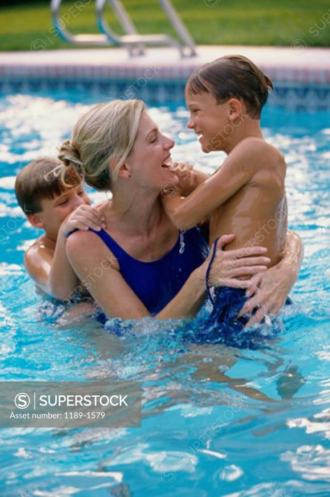 Stock Photo: 1189-1579 High angle view of a mother and her two sons in a swimming pool