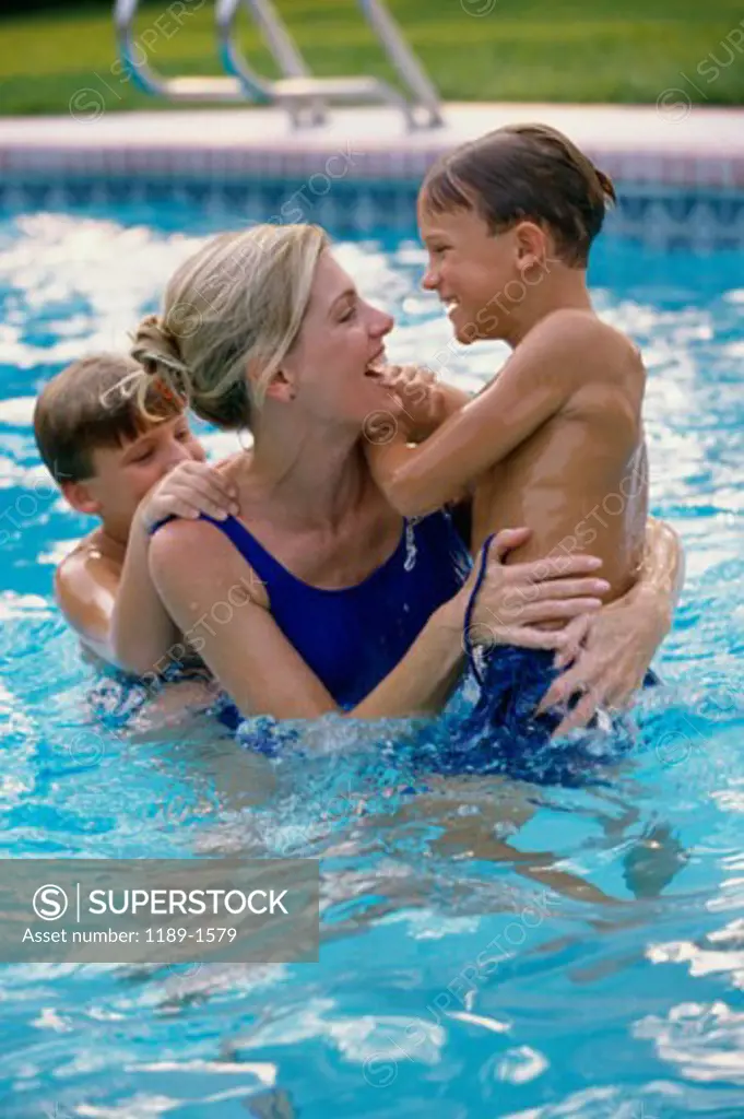High angle view of a mother and her two sons in a swimming pool