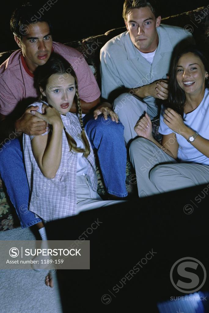 Stock Photo: 1189-159 Two young couples watching television