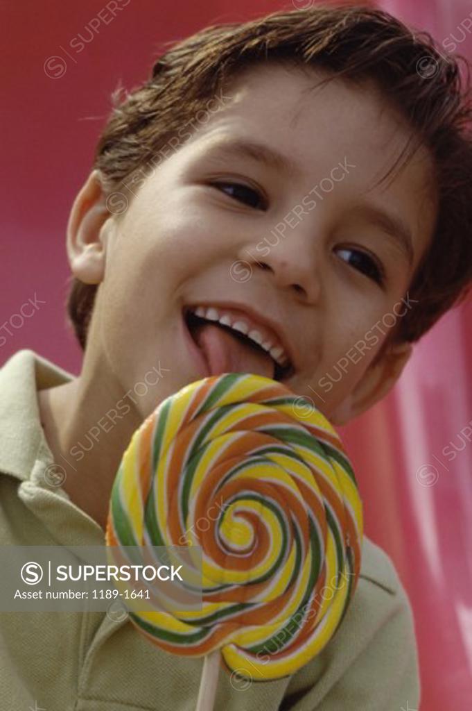 Stock Photo: 1189-1641 Close-up of a boy licking a lollipop