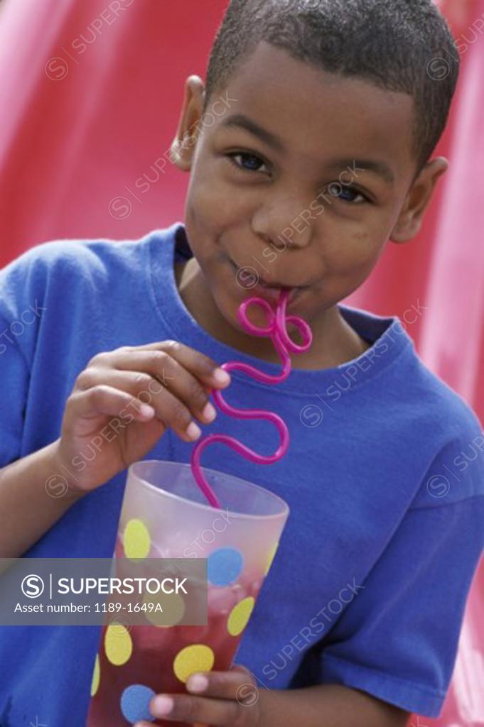 Stock Photo: 1189-1649A Portrait of a boy drinking with a straw