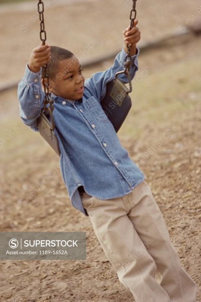 Stock Photo: 1189-1652A High angle view of a boy swinging on a swing