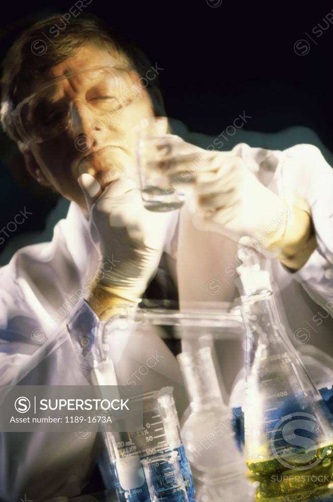 Stock Photo: 1189-1673A Male scientist looking at a beaker in a laboratory