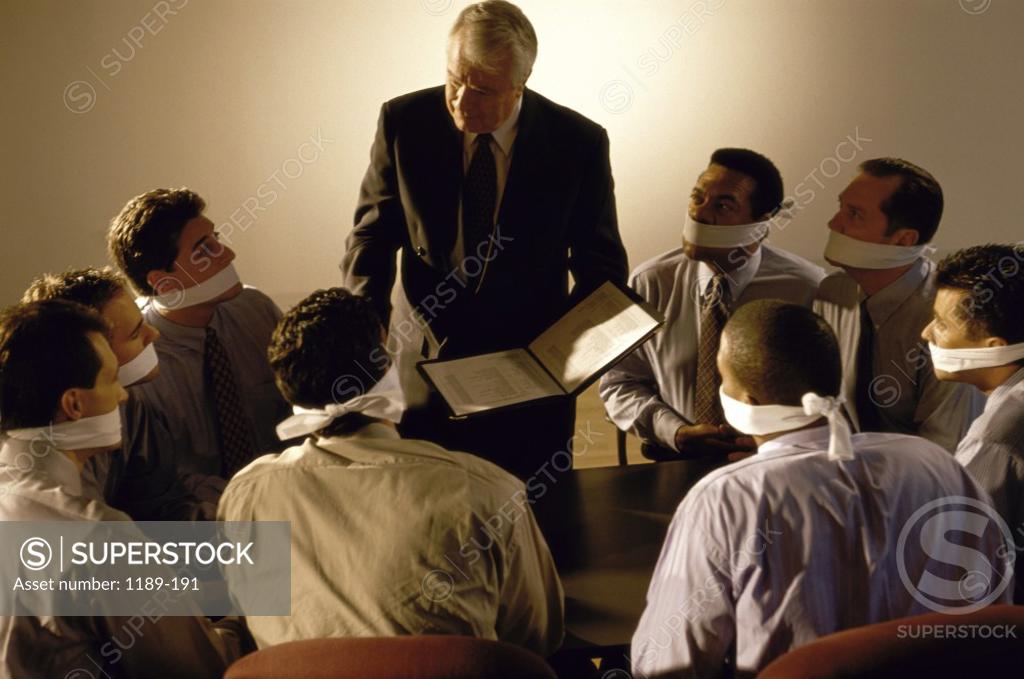 Stock Photo: 1189-191 Group of businessmen gagged with white cloth