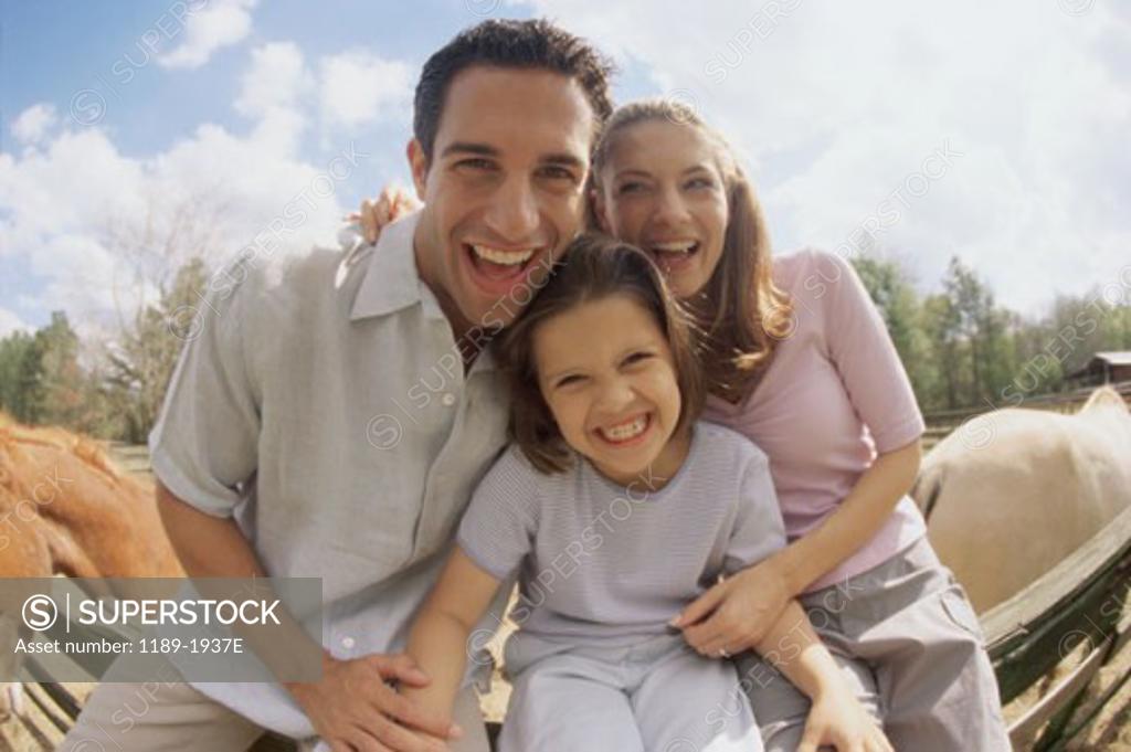 Stock Photo: 1189-1937E Mid adult couple with their daughter smiling
