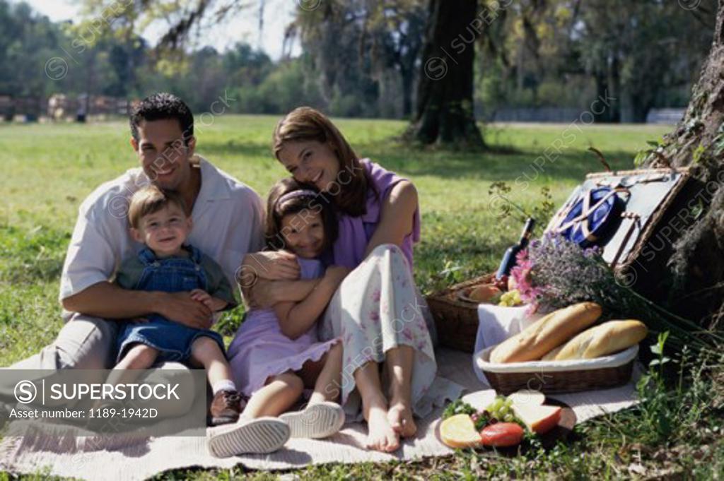 Stock Photo: 1189-1942D Parents with their son and daughter at a picnic
