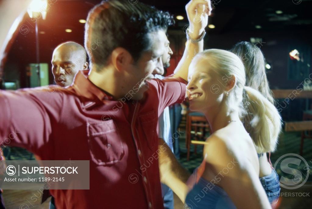 Stock Photo: 1189-2145 Close-up of a young couple dancing in a nightclub