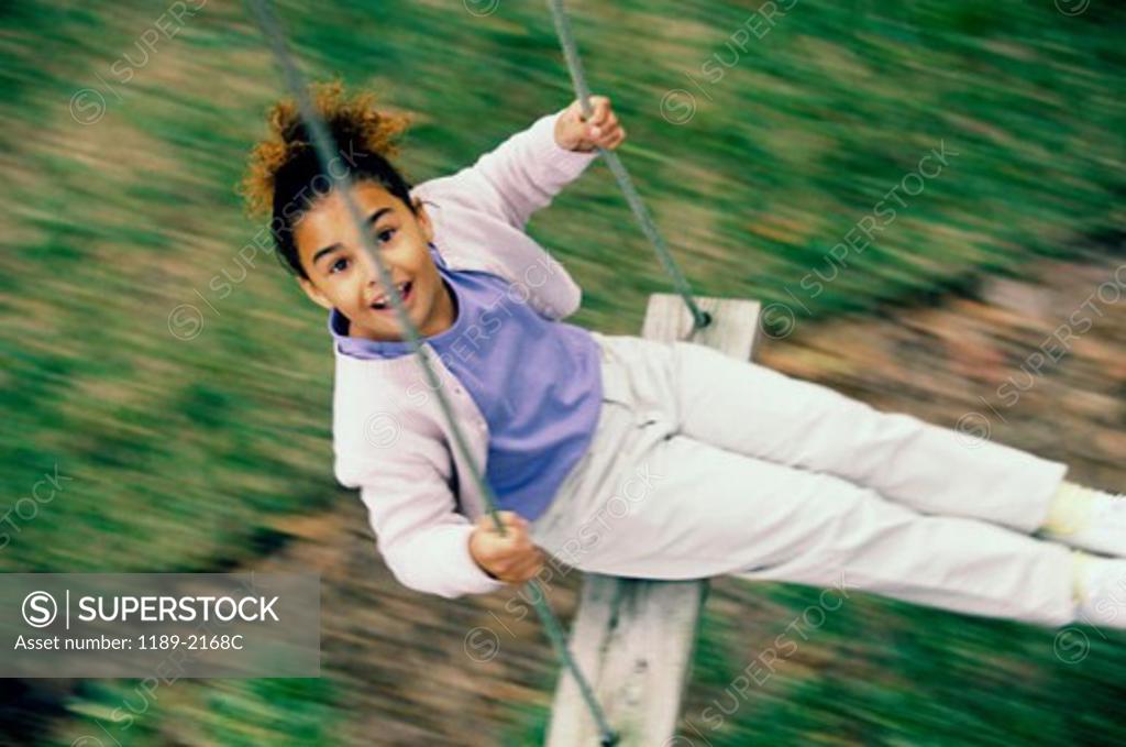 Stock Photo: 1189-2168C High angle view of a girl swinging on a swing