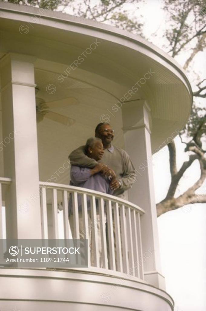 Stock Photo: 1189-2174A Low angle view of a senior couple standing on the balcony