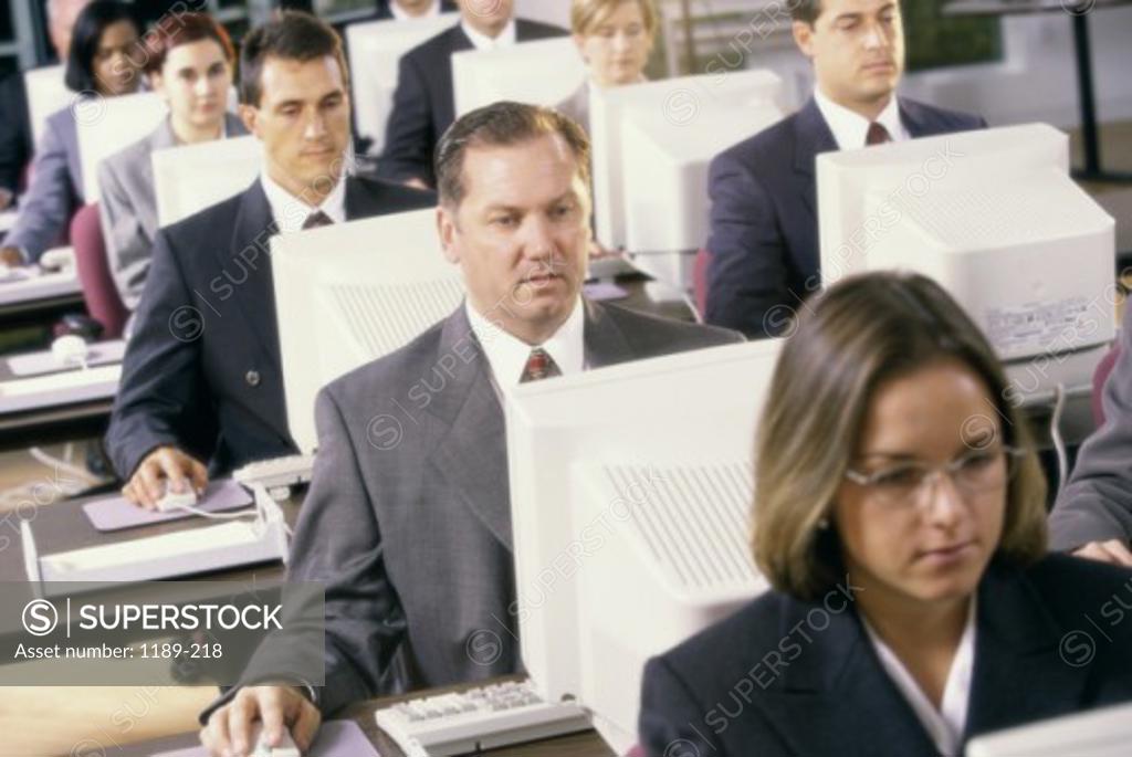 Stock Photo: 1189-218 Group of business executives in front of computer monitors