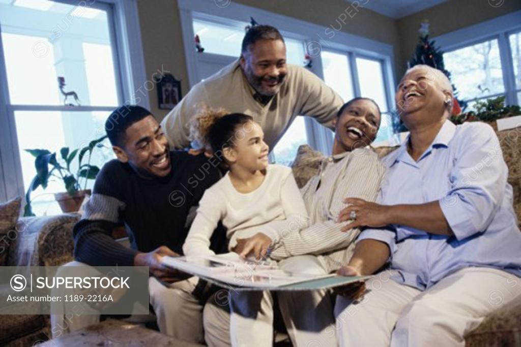 Stock Photo: 1189-2216A Family sitting together looking at a photo album