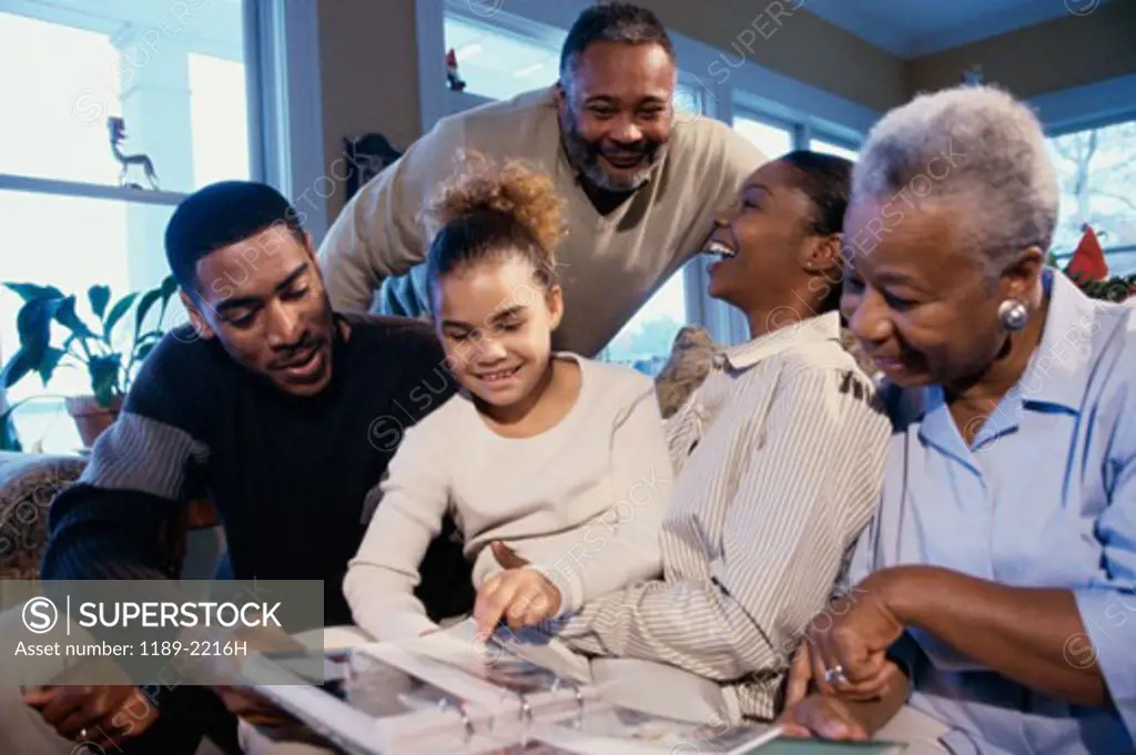 Family sitting together and looking at a photo album
