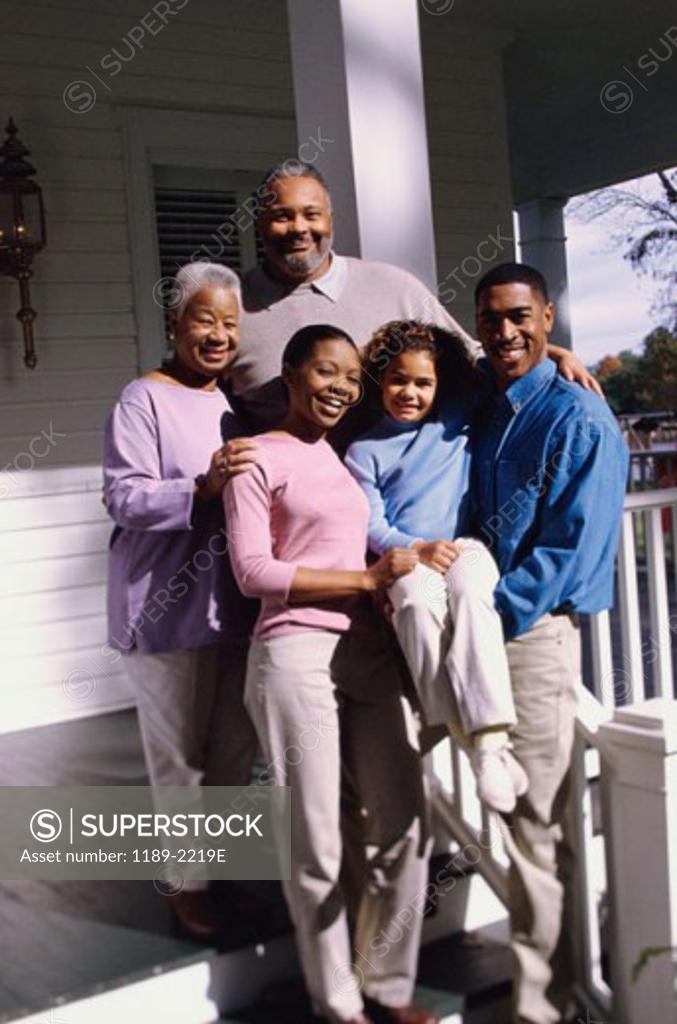 Stock Photo: 1189-2219E Family standing in front of a house