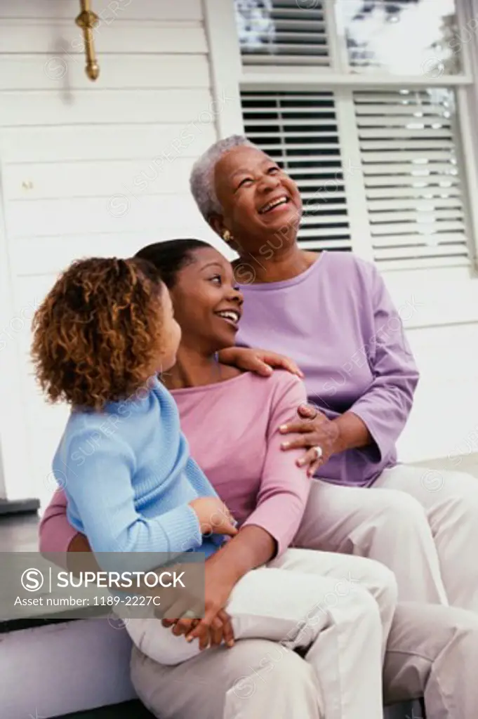 Girl sitting with her mother and grandmother