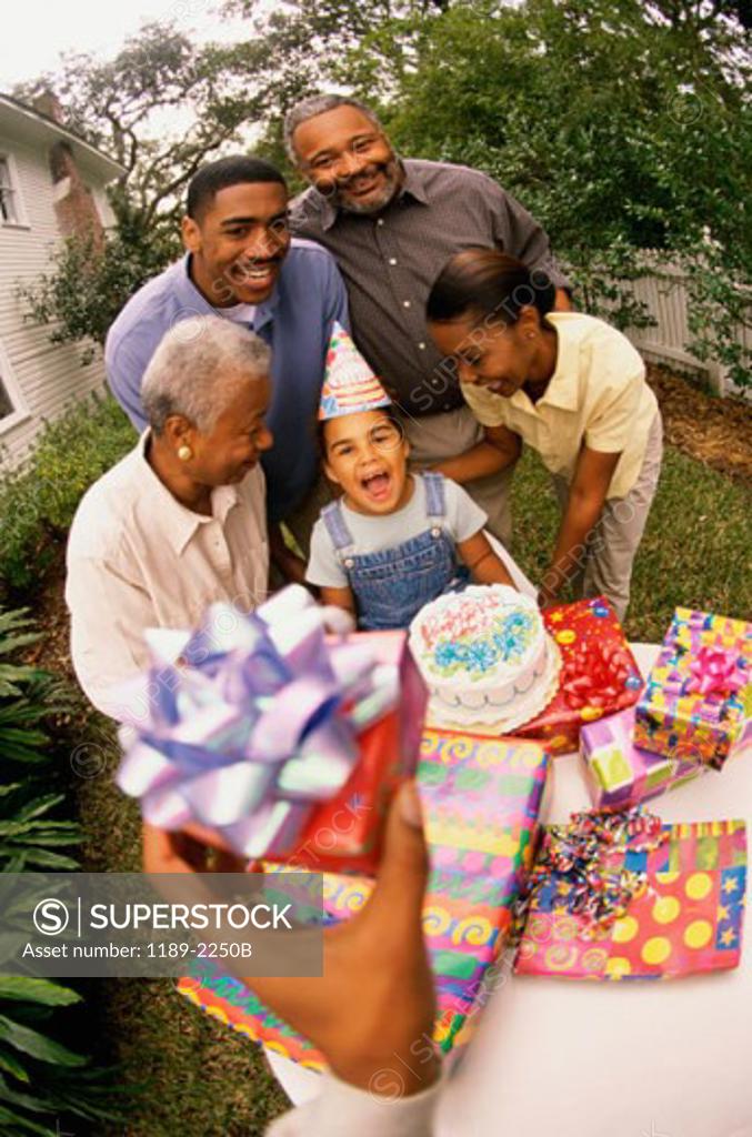 Stock Photo: 1189-2250B High angle view of a girl celebrating her birthday with her parents and grandparents