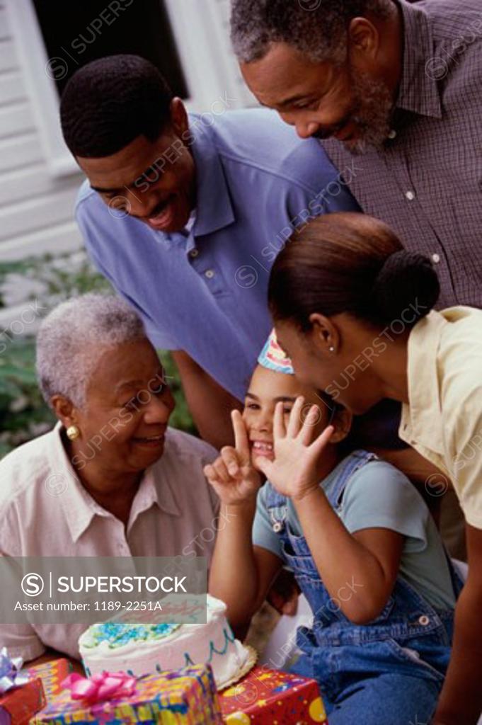 Stock Photo: 1189-2251A Close-up of a girl celebrating her birthday with her parents and grandparents