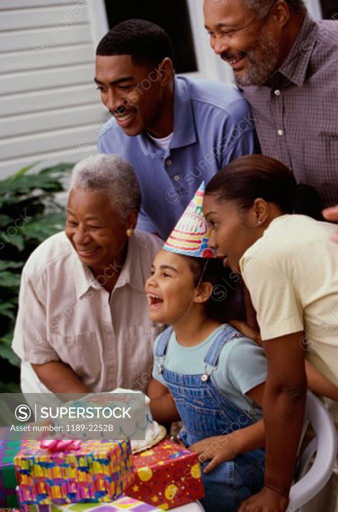 Stock Photo: 1189-2252B Girl celebrating her birthday with her parents and grandparents