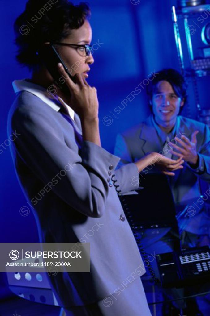 Stock Photo: 1189-2380A Businessman looking at a businesswoman in an office