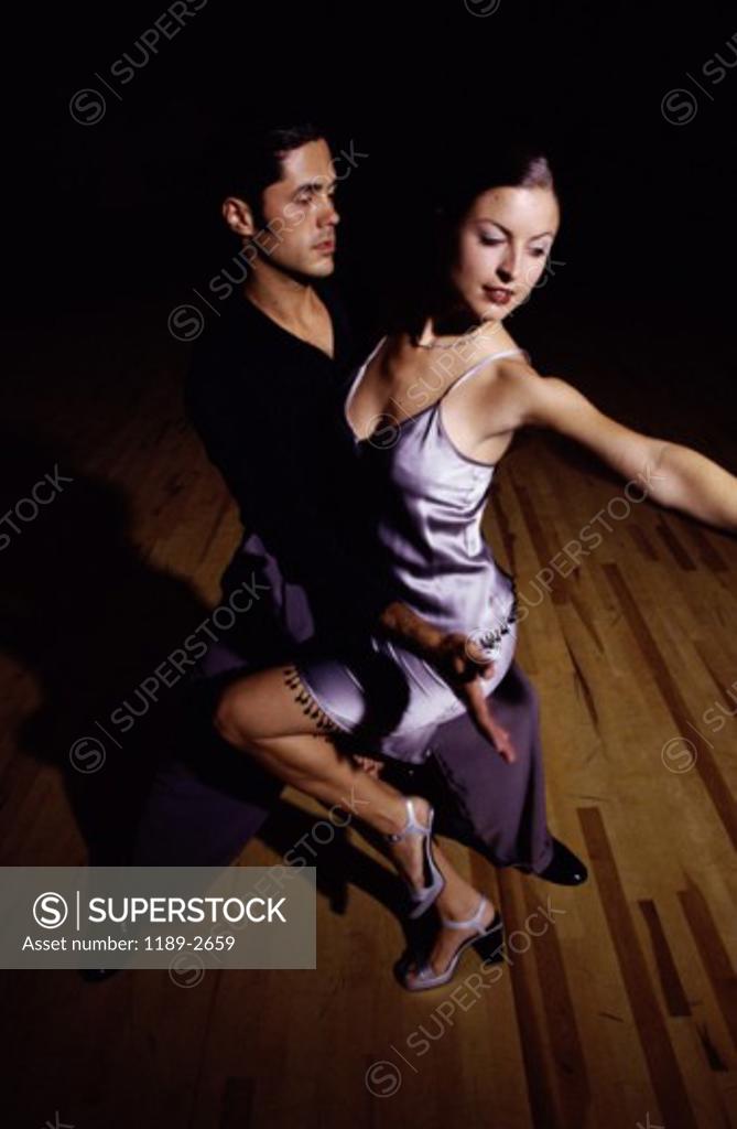 Stock Photo: 1189-2659 Young couple dancing in a nightclub