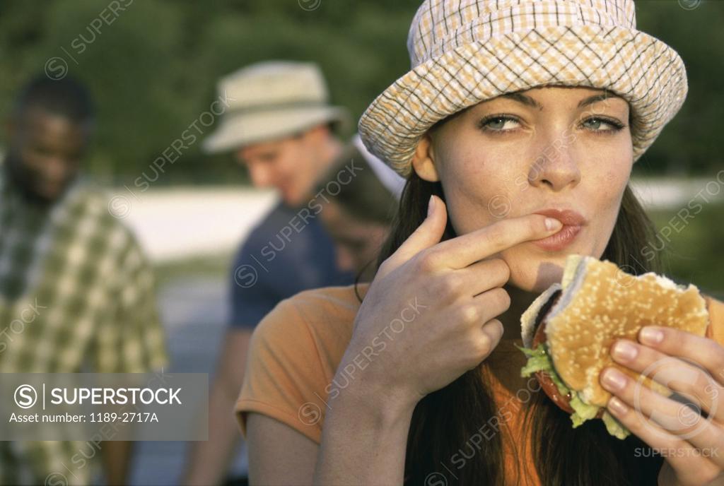 Stock Photo: 1189-2717A Young woman eating a burger