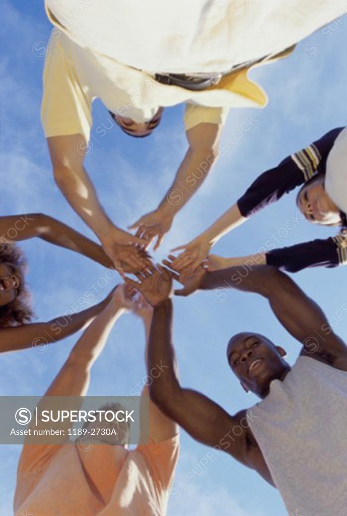 Stock Photo: 1189-2730A Low angle view of a group of young people in a huddle