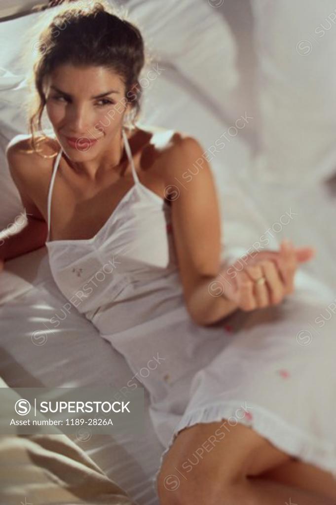 Stock Photo: 1189-2826A High angle view of a young woman lying on a bed
