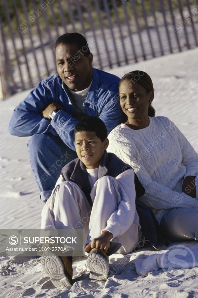 Stock Photo: 1189-2970A Mid adult couple on the beach with their son