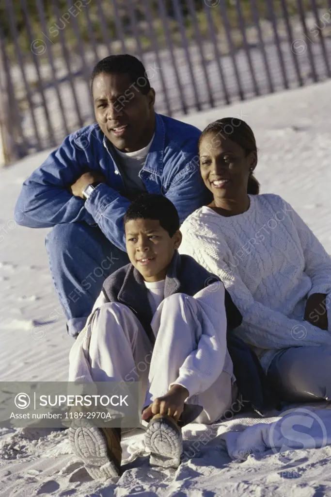 Mid adult couple on the beach with their son