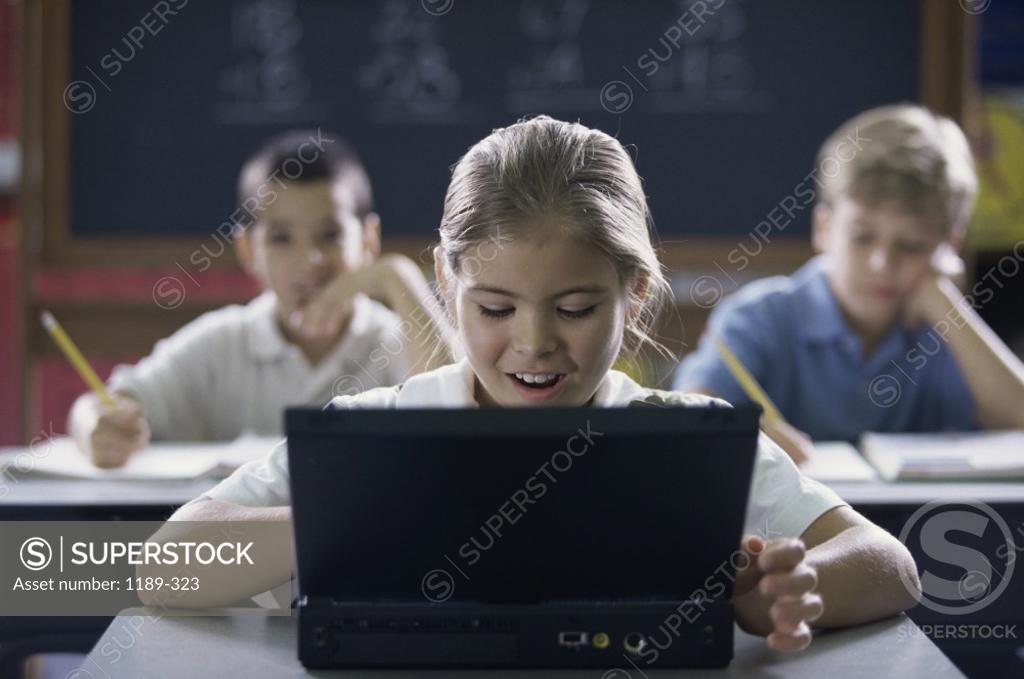 Stock Photo: 1189-323 Children using a computer in a classroom