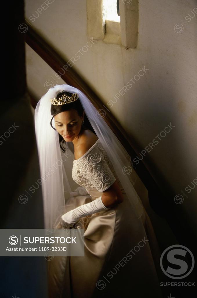 Stock Photo: 1189-3233D Bride moving up on a staircase