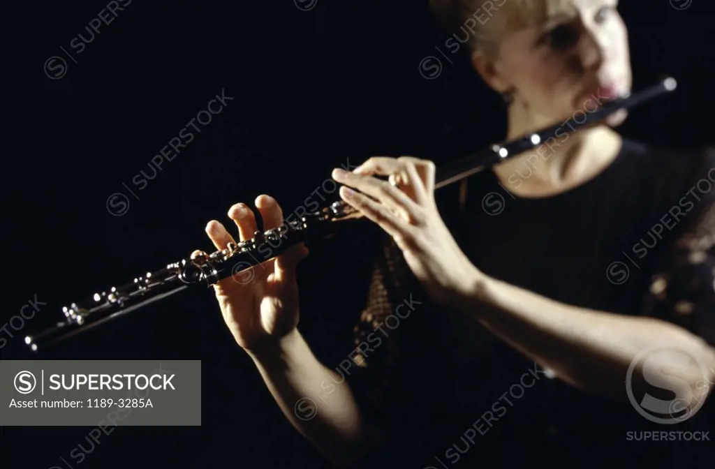 Young woman playing the flute
