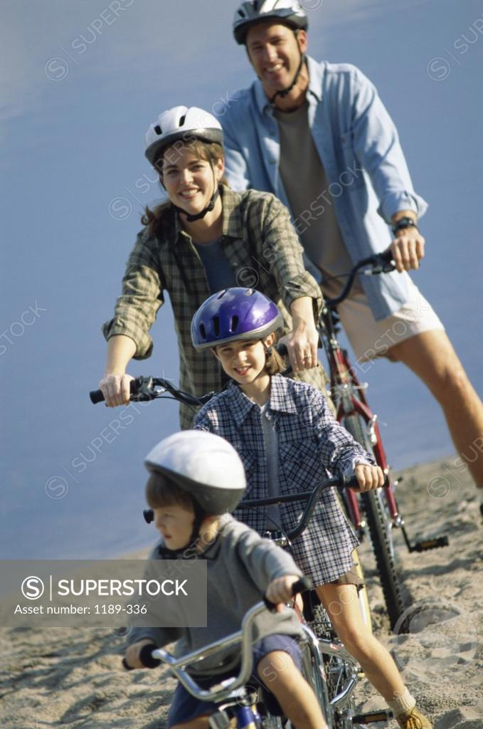 Stock Photo: 1189-336 Parents cycling with their son and daughter