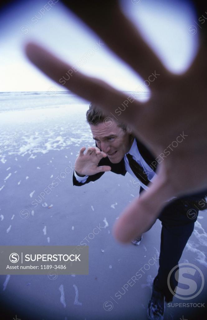 Stock Photo: 1189-3486 Businessman shielding his face with his hand