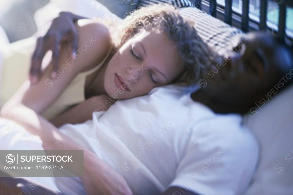 Stock Photo: 1189-3711A High angle view of a young couple sleeping in bed