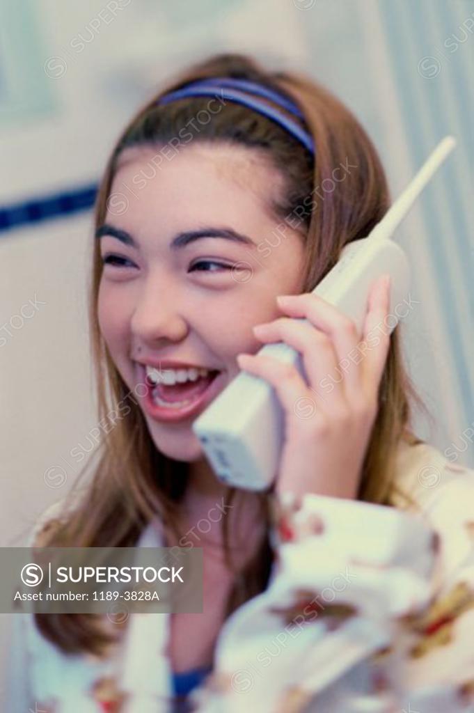 Stock Photo: 1189-3828A Close-up of a teenage girl talking on a cordless phone