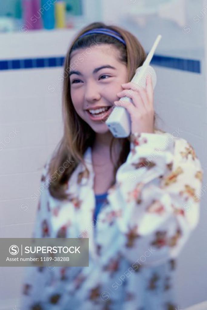 Stock Photo: 1189-3828B Teenage girl talking on a cordless phone