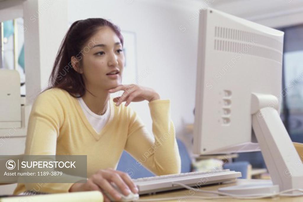 Stock Photo: 1189-3879 Young woman working on a computer